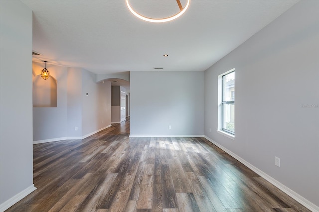 spare room with dark wood-type flooring