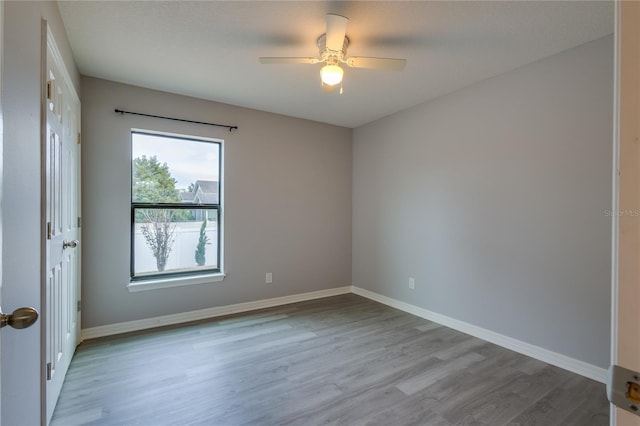 empty room featuring ceiling fan and light hardwood / wood-style flooring