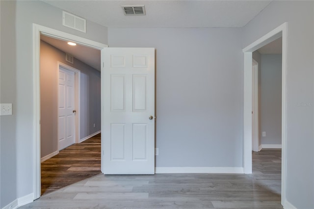 spare room featuring light hardwood / wood-style floors