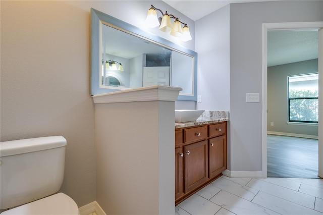 bathroom featuring vanity and toilet