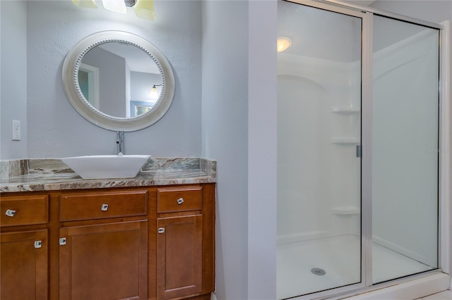 bathroom featuring vanity and an enclosed shower