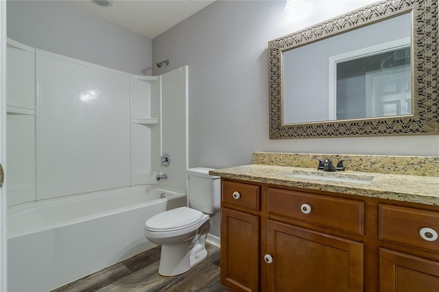 full bathroom with bathtub / shower combination, hardwood / wood-style floors, toilet, and vanity