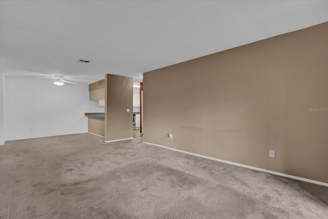 unfurnished room with light colored carpet and ceiling fan