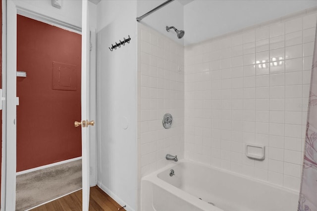 bathroom featuring shower / bath combo with shower curtain and hardwood / wood-style floors