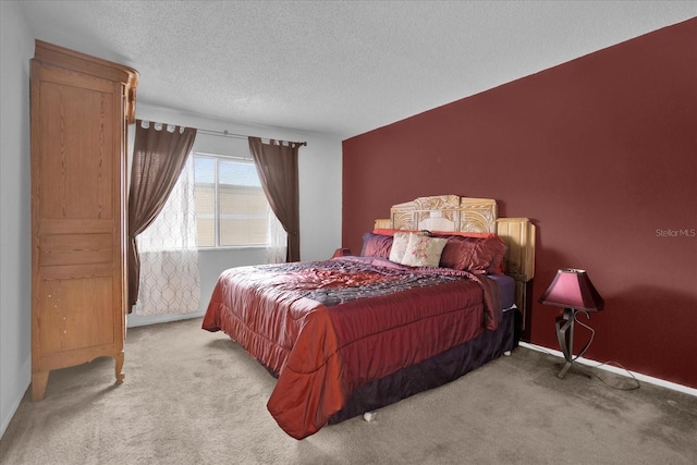 bedroom with a textured ceiling and light carpet