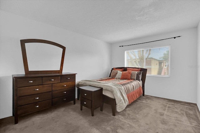 carpeted bedroom featuring a textured ceiling