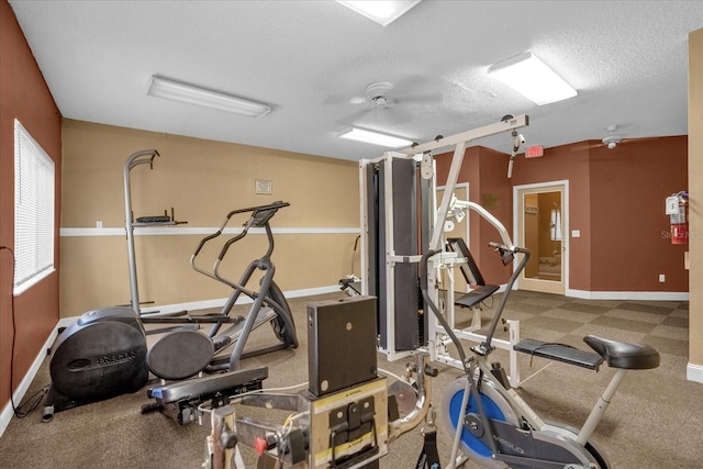 exercise room featuring a textured ceiling and ceiling fan