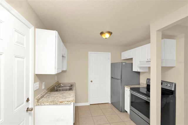 kitchen featuring stainless steel appliances, white cabinetry, a textured ceiling, light tile patterned floors, and sink