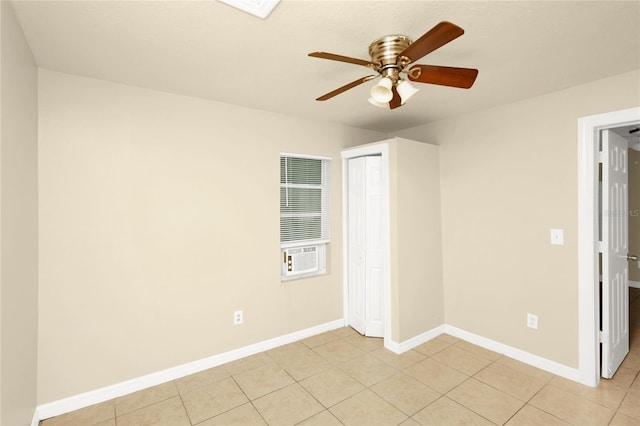 empty room with light tile patterned floors and ceiling fan