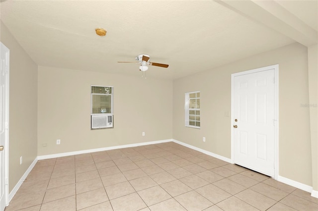 empty room featuring light tile patterned floors and ceiling fan