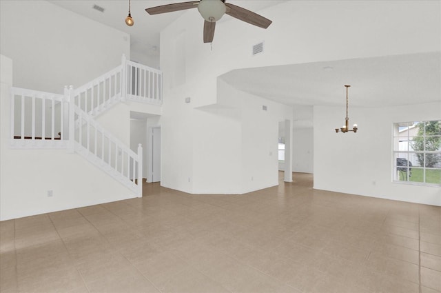 14646 Brightwell Ct, Orlando, FL 32824 - unfurnished living room with a chandelier, stairs, a towering ceiling, and ceiling fan