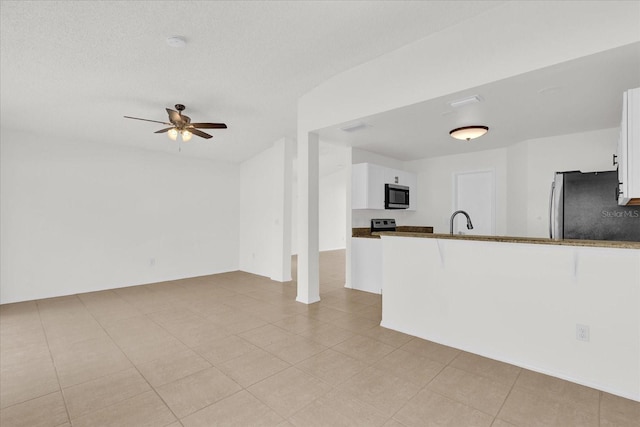 kitchen with stainless steel appliances, white cabinetry, sink, and kitchen peninsula