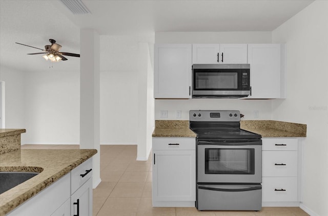 kitchen featuring white cabinets, stone countertops, and stainless steel appliances