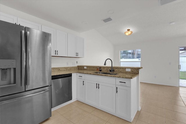 kitchen featuring white cabinetry, sink, kitchen peninsula, appliances with stainless steel finishes, and dark stone counters