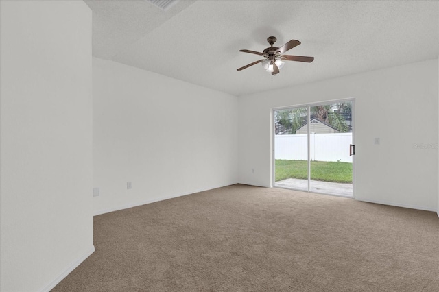 empty room featuring ceiling fan, a textured ceiling, and carpet flooring