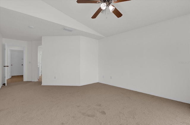 unfurnished room with ceiling fan, light carpet, and vaulted ceiling