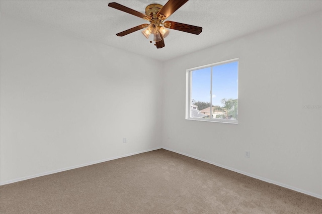 empty room with ceiling fan, a textured ceiling, and carpet floors