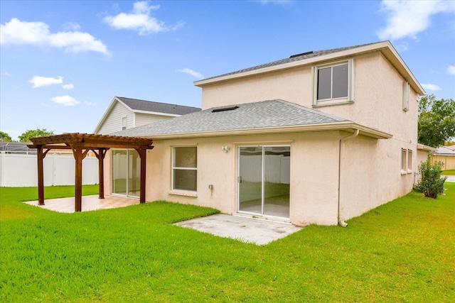 rear view of property with a pergola, a yard, and a patio area