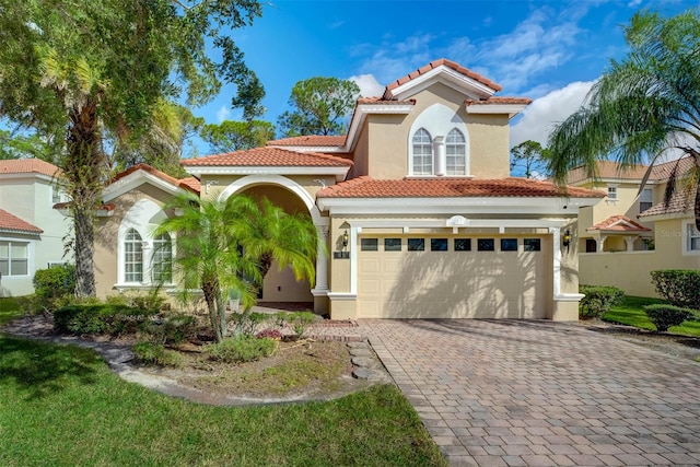 mediterranean / spanish-style house with a garage