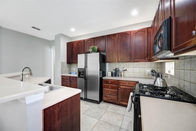 kitchen featuring black appliances, sink, backsplash, and light tile patterned flooring