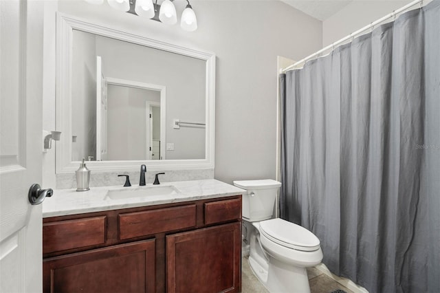 bathroom featuring tile patterned floors, vanity, and toilet