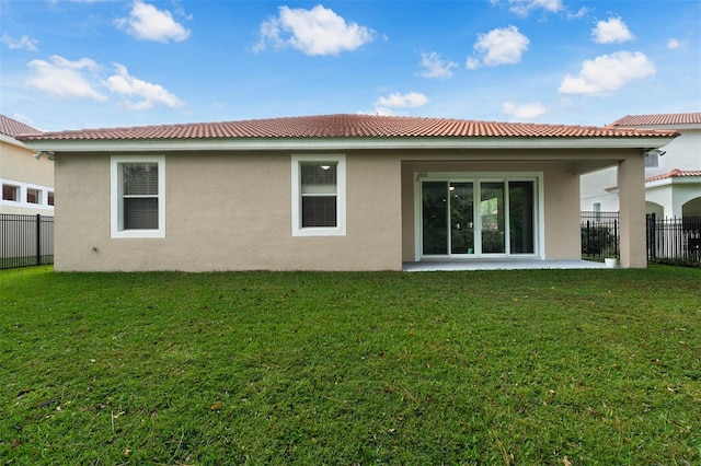 back of house with a lawn