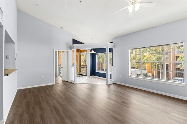 unfurnished living room with plenty of natural light, ceiling fan, and light wood-type flooring