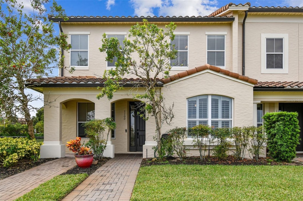 mediterranean / spanish-style home featuring a front lawn