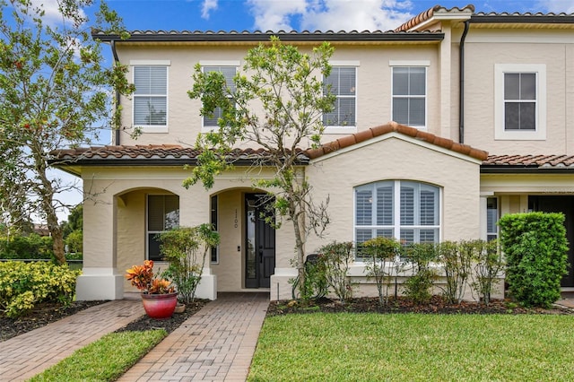 mediterranean / spanish-style home featuring a front lawn