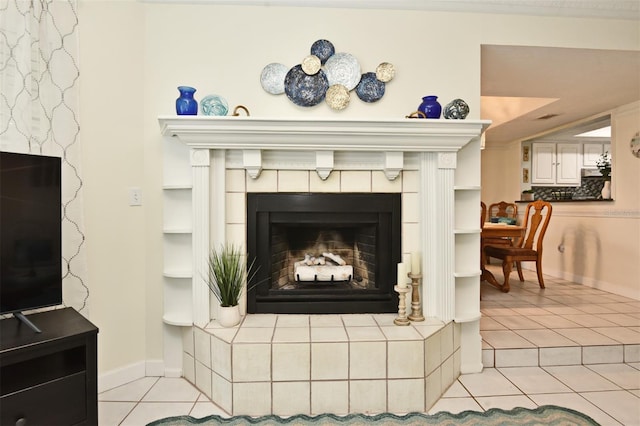 interior details featuring a tile fireplace