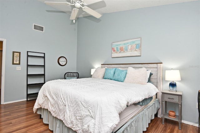 bedroom with ceiling fan, dark hardwood / wood-style flooring, and vaulted ceiling