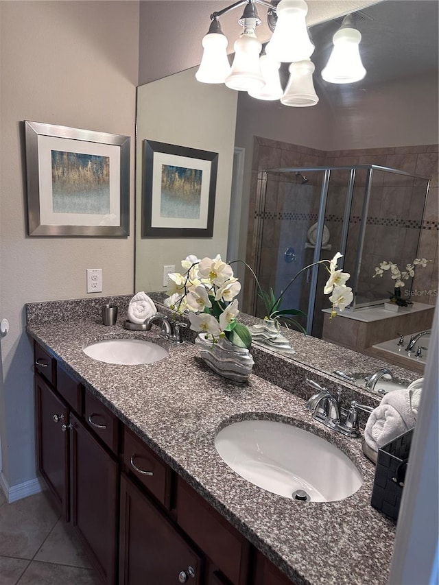 bathroom with tile patterned flooring, vanity, and a shower with door