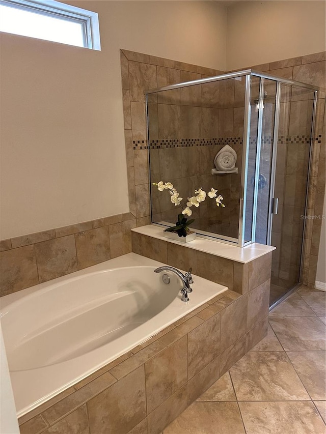 bathroom with tile patterned flooring and independent shower and bath