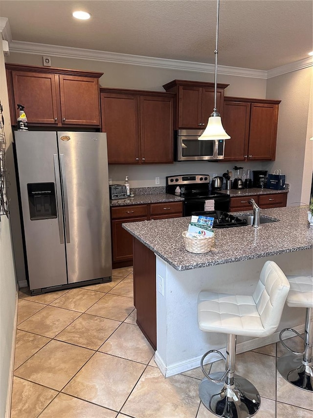 kitchen featuring a breakfast bar, stainless steel appliances, stone counters, and light tile patterned flooring