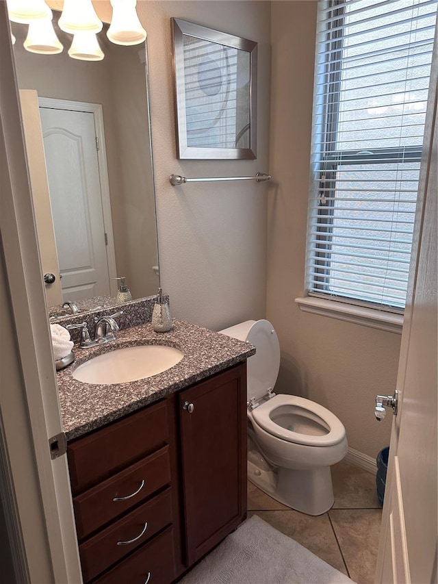 bathroom with tile patterned floors, vanity, and toilet