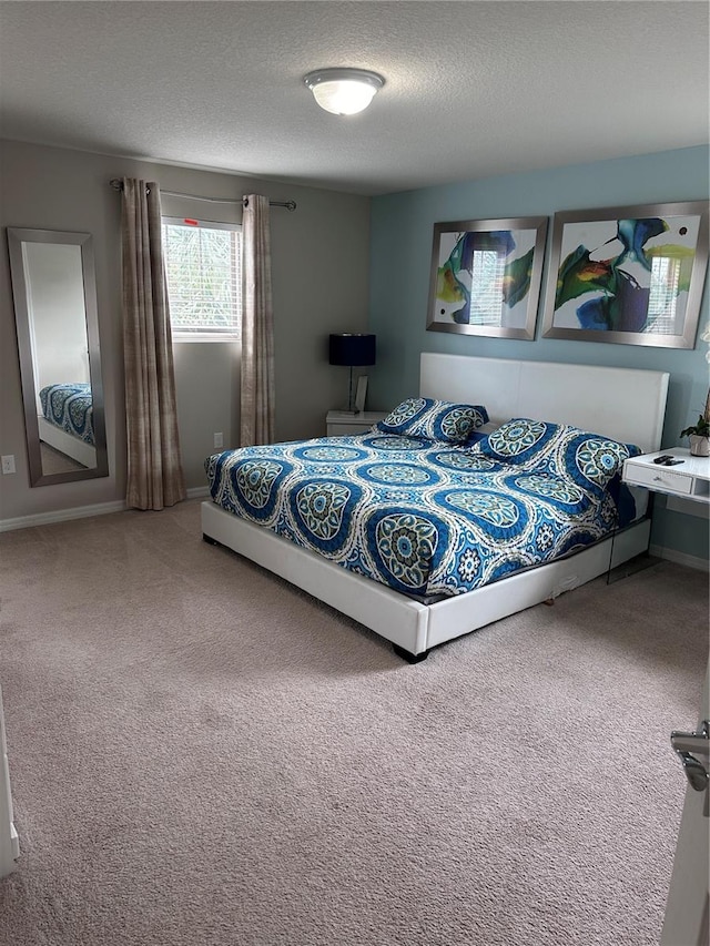 bedroom with a textured ceiling and carpet floors