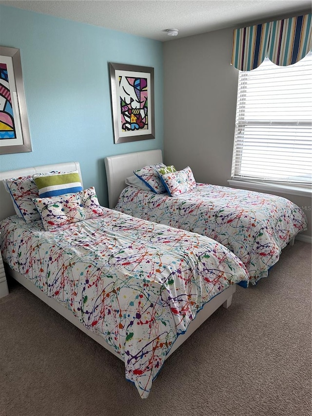 bedroom with a textured ceiling and carpet floors