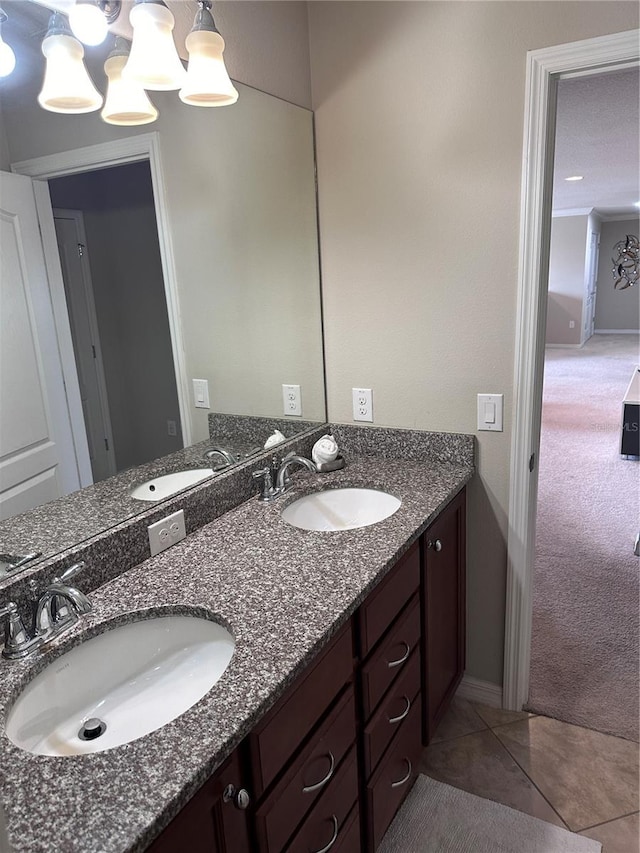 bathroom featuring tile patterned floors, vanity, and an inviting chandelier