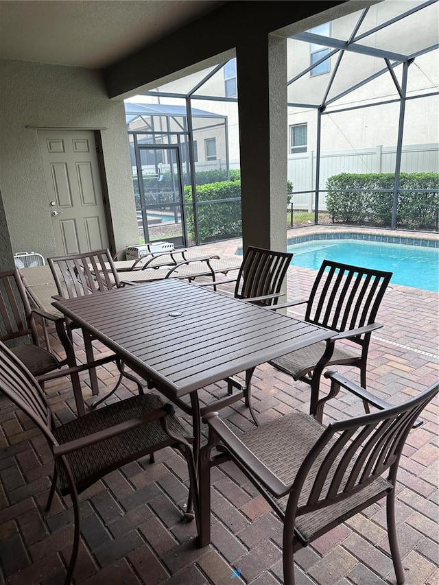 view of patio / terrace featuring glass enclosure