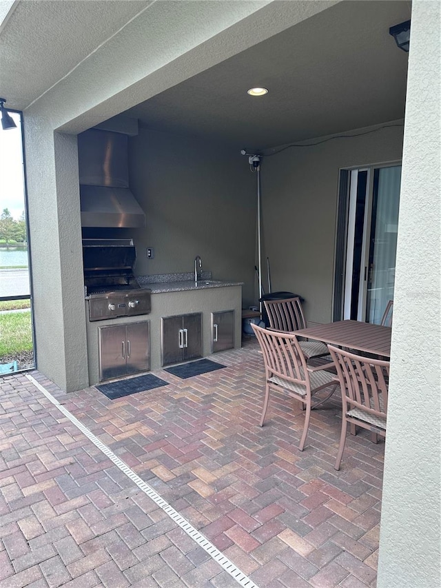 view of patio featuring a grill, sink, and exterior kitchen