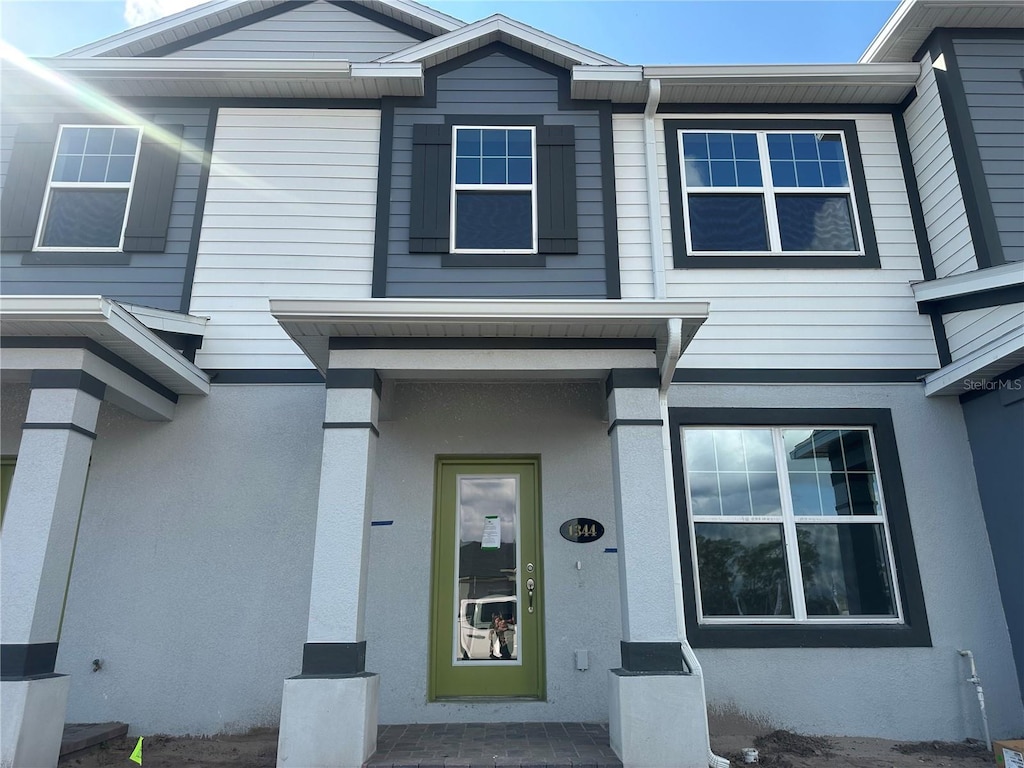 property entrance with stucco siding