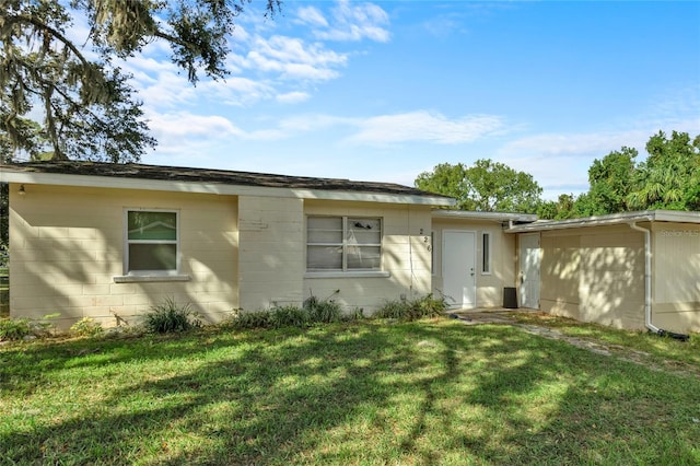 rear view of property with a yard