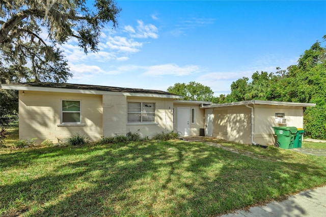 ranch-style house with a front lawn