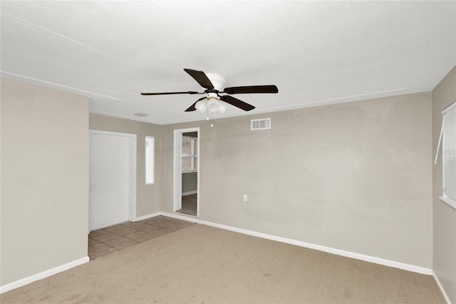 carpeted empty room with ceiling fan