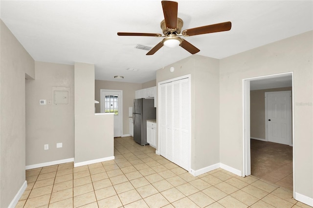 spare room with light tile patterned floors and ceiling fan