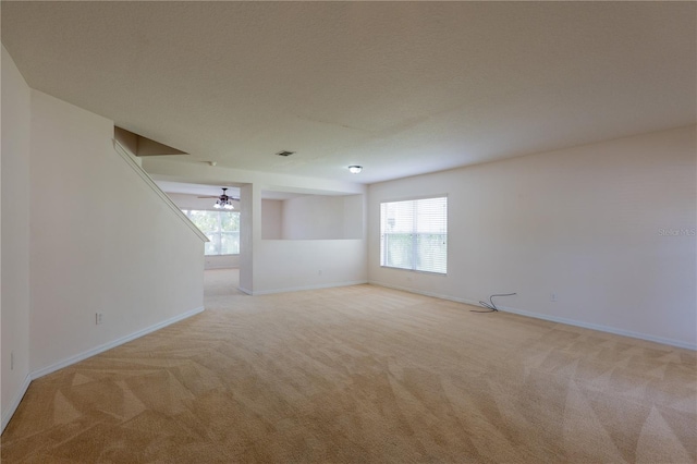 unfurnished room featuring light carpet and ceiling fan