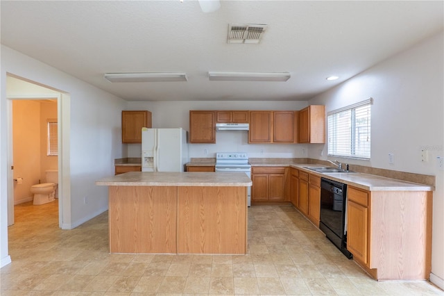 kitchen with sink, white appliances, and a kitchen island