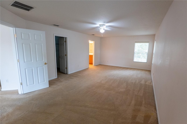 unfurnished room with ceiling fan and light carpet