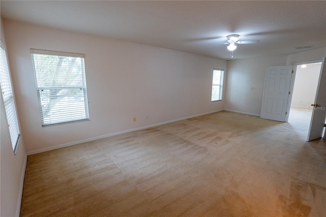 carpeted spare room with ceiling fan and a textured ceiling