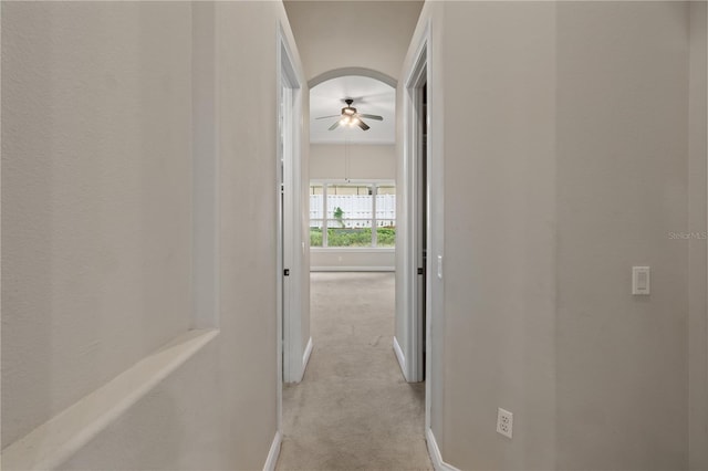 hall with light colored carpet